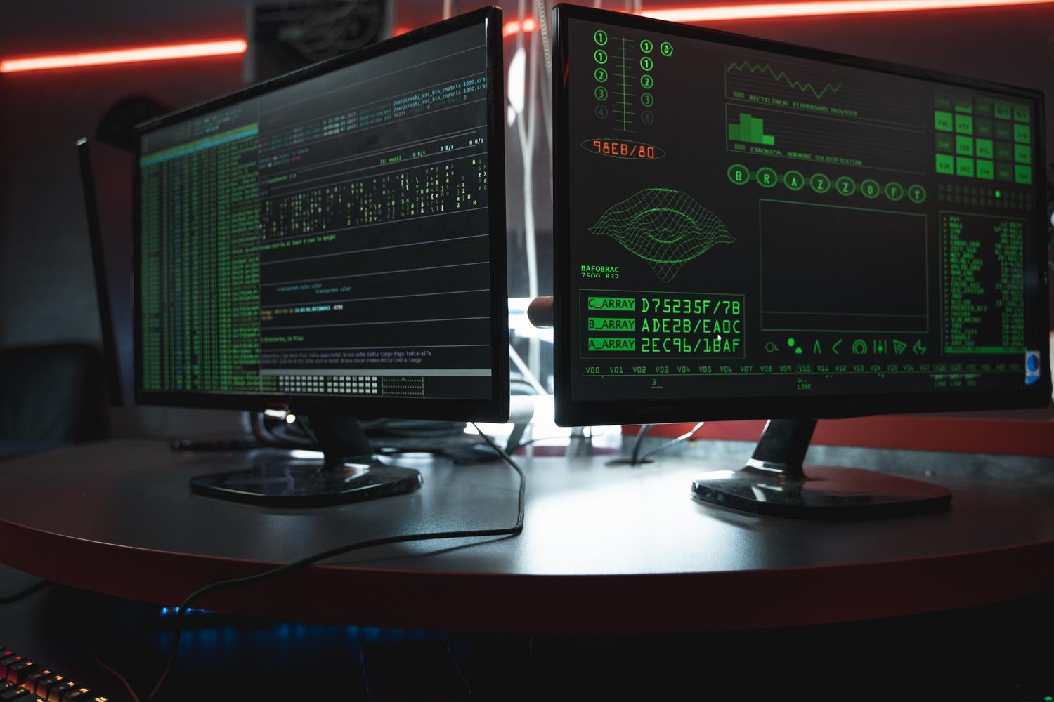 Almacenamiento de hashes Primer plano de monitores de computadora con interfaces de código verde sobre fondo negro, simulando el almacenamiento de hashes y datos encriptados.