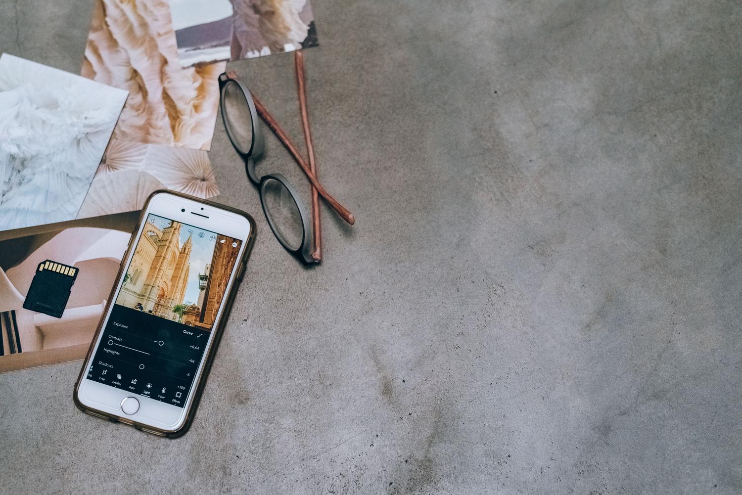 Smartphone y tarjeta de memoria junto a fotografías impresas, representando la recuperación de archivos Smartphone y tarjeta de memoria junto a fotografías impresas, representando la recuperación de archivos